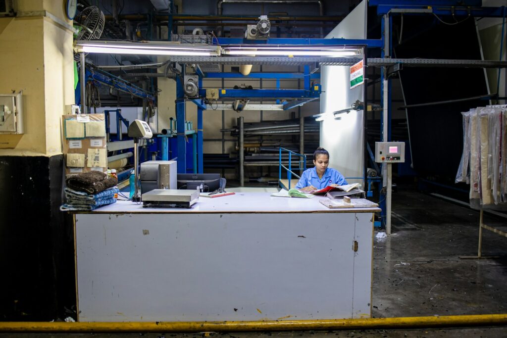 Woman works at a factory control desk.