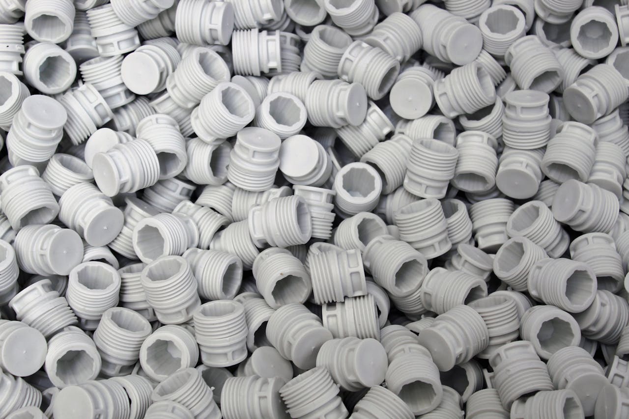 Close-up of White Plastic Screw Caps in Bulk